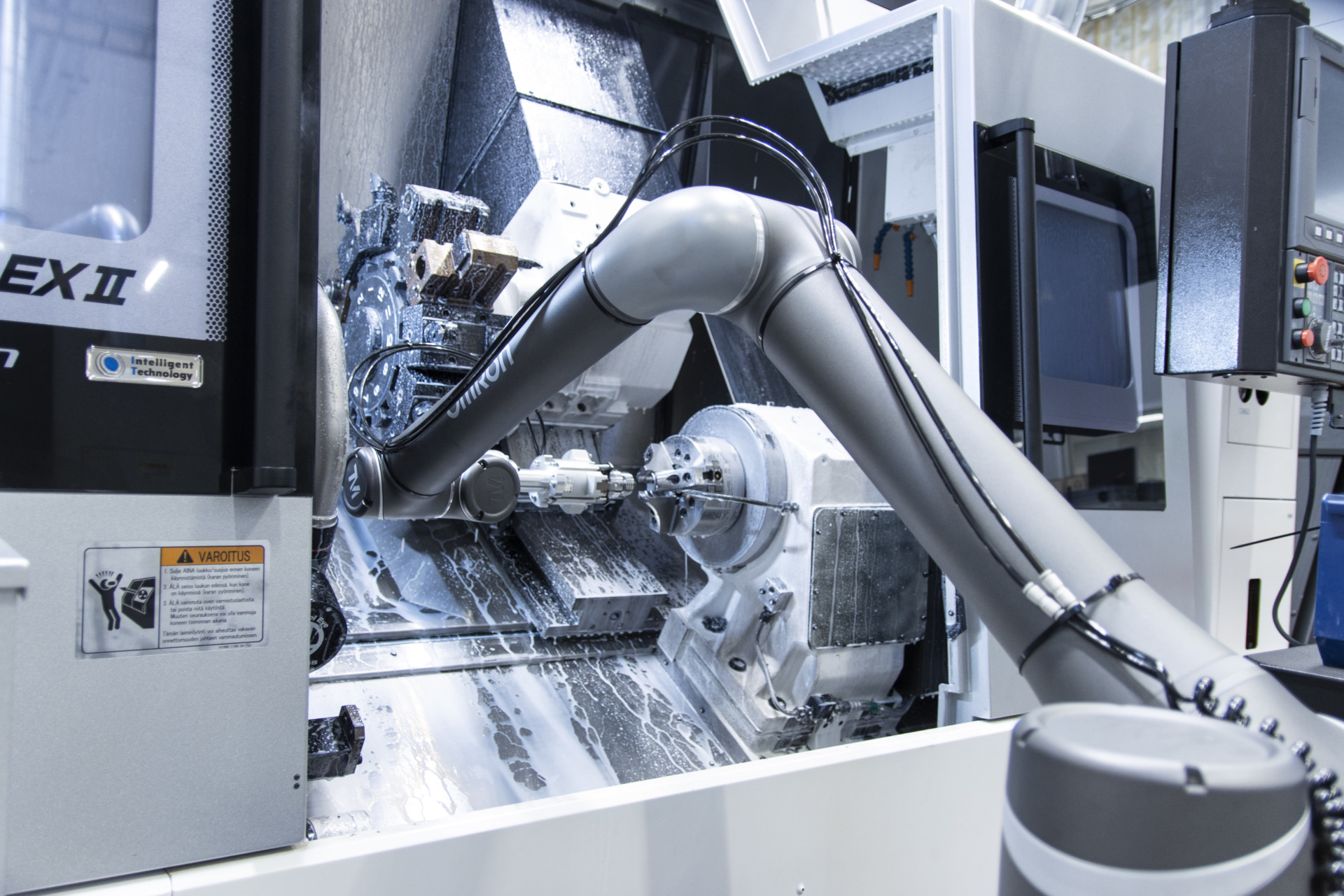 A co-bot removing an item from a machining centre