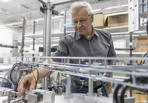 An older man takes a look at an automation unit