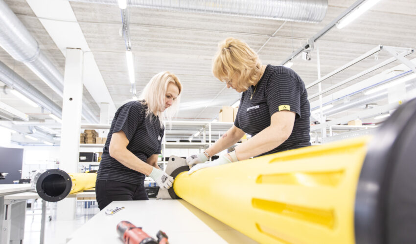 Two women assembling a marine light