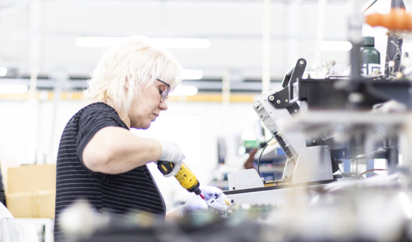 A woman screwing a component