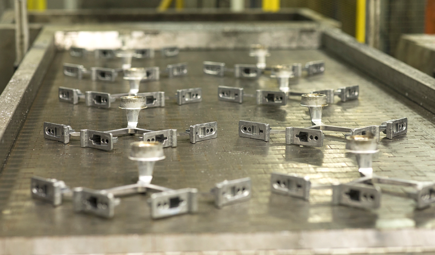 Die casted components on a production line